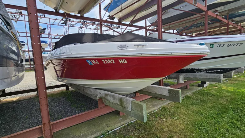 Slide: The Image of 2008 Sea Ray 205 Sport boat in dry storage, red and white hull. - 3