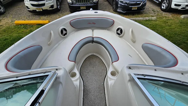 Slide: The Image of 2008 Sea Ray 205 Sport boat interior with cushioned seating and speakers. - 8
