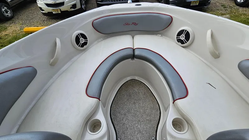 Slide: The Image of 2008 Sea Ray 205 Sport boat interior with gray and white seating. - 9