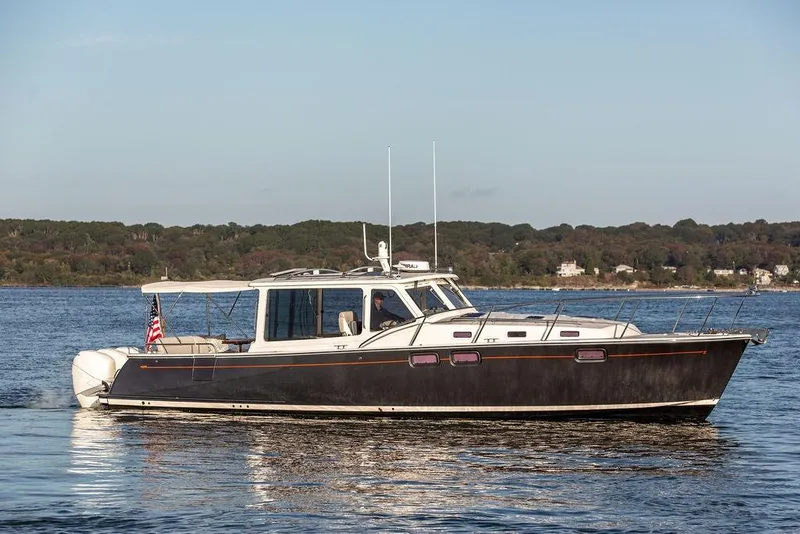 The Image of 2018 MJM 43z yacht cruising on a calm lake with scenic shoreline. - 0