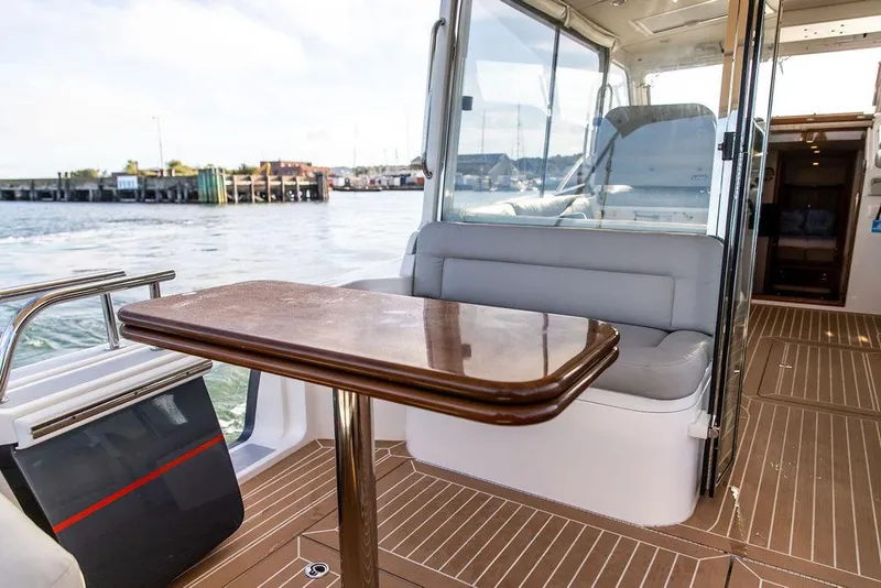 Slide: The Image of Interior view of 2018 MJM 43z yacht with seating and wooden table. - 16
