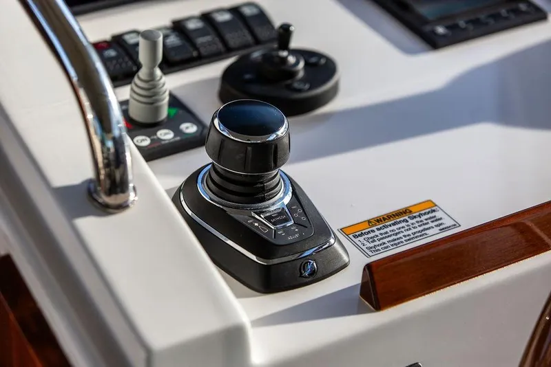 Slide: The Image of Control panel of 2018 MJM 43z boat with joystick and warning label. - 21