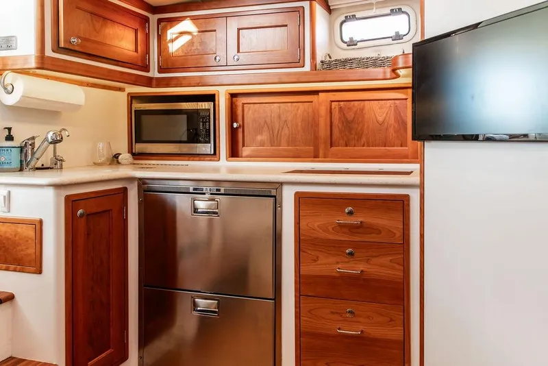Slide: The Image of Luxurious 2018 MJM 43z yacht kitchen with wood cabinetry and modern appliances. - 35
