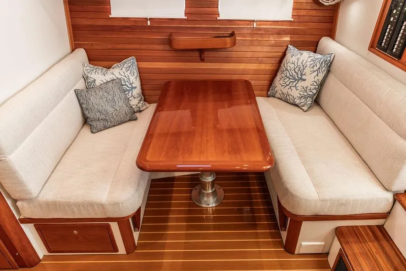Slide: The Image of Luxurious 2018 MJM 43z yacht interior with elegant wood table and cushioned seating. - 36