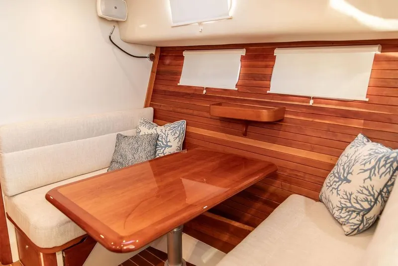 Slide: The Image of Interior of 2018 MJM 43z yacht with wooden table and cushioned seating. - 37