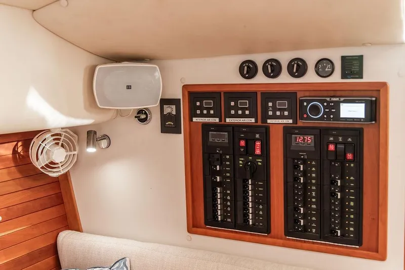 Slide: The Image of Control panel inside 2018 MJM 43z boat, featuring switches, gauges, and speaker. - 41