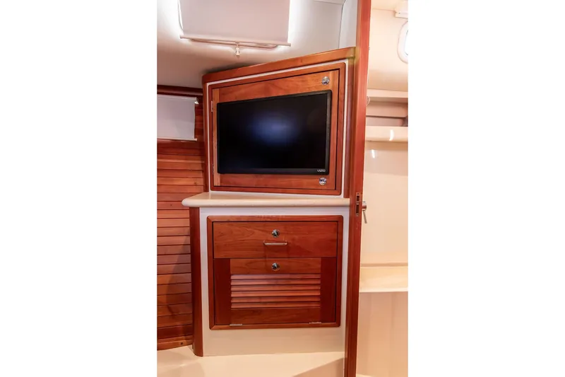 Slide: The Image of 2018 MJM 43z yacht interior with wooden cabinetry and built-in TV. - 42