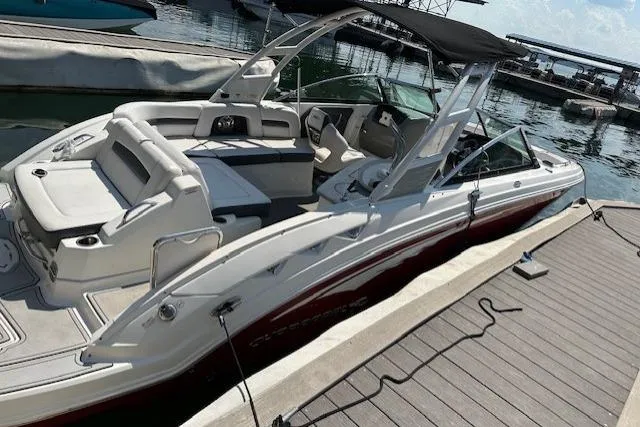 Slide: The Image of 2016 Chaparral 264 Sunesta boat docked at marina, featuring sleek design and spacious seating. - 12
