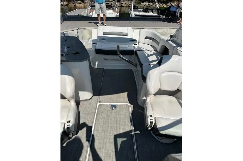 Slide: The Image of 2016 Chaparral 264 Sunesta boat interior with white seating and deck view. - 16