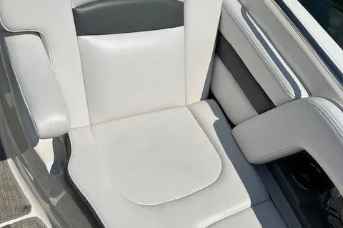 Slide: The Image of 2016 Chaparral 264 Sunesta boat seat, white and gray upholstery, close-up view. - 18