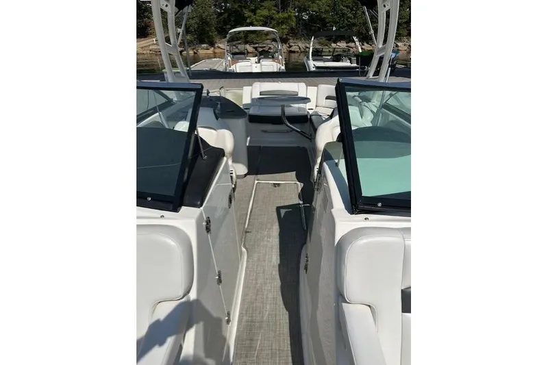 Slide: The Image of 2016 Chaparral 264 Sunesta boat interior with white seating and glass windshields. - 19