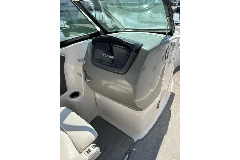 Slide: The Image of 2016 Chaparral 264 Sunesta boat interior with storage compartment and seating. - 21