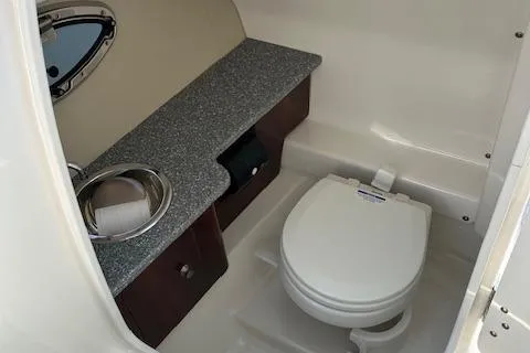 Slide: The Image of 2016 Chaparral 264 Sunesta boat bathroom with sink and toilet. - 22