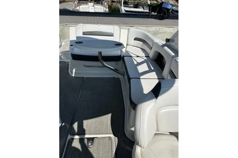 Slide: The Image of 2016 Chaparral 264 Sunesta boat interior with white seating and table. - 23