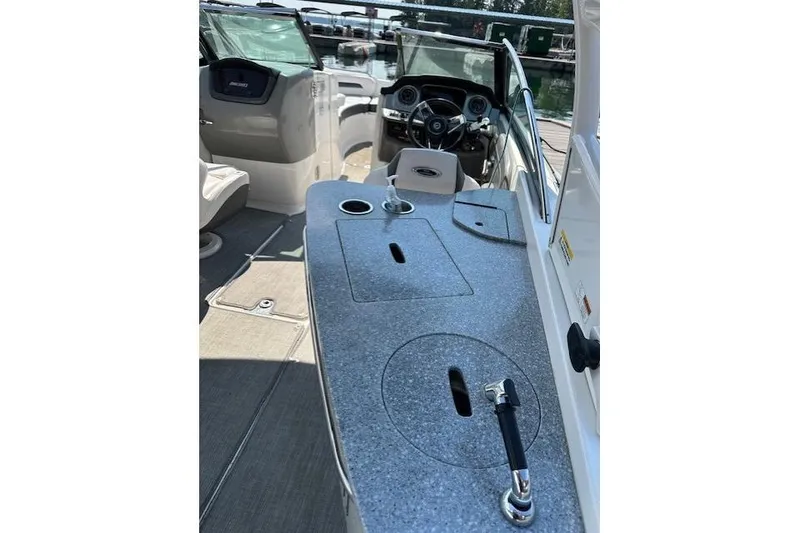 Slide: The Image of 2016 Chaparral 264 Sunesta boat interior with steering wheel and seating area. - 26