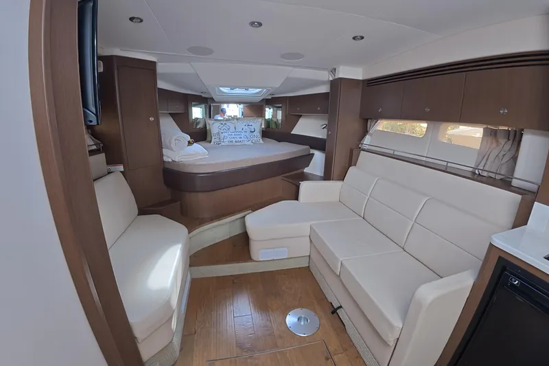 Slide: The Image of 2021 Sea Ray Sundancer 350 Coupe interior with elegant seating and cozy sleeping area. - 11