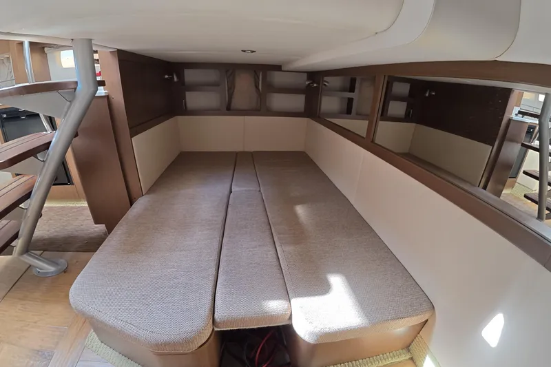 Slide: The Image of Interior cabin of 2021 Sea Ray Sundancer 350 Coupe with cozy seating and wooden accents. - 17