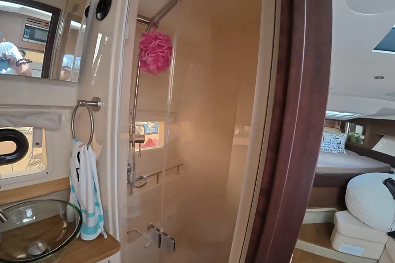Slide: The Image of Interior of 2021 Sea Ray Sundancer 350 Coupe, featuring bathroom and bedroom areas. - 19