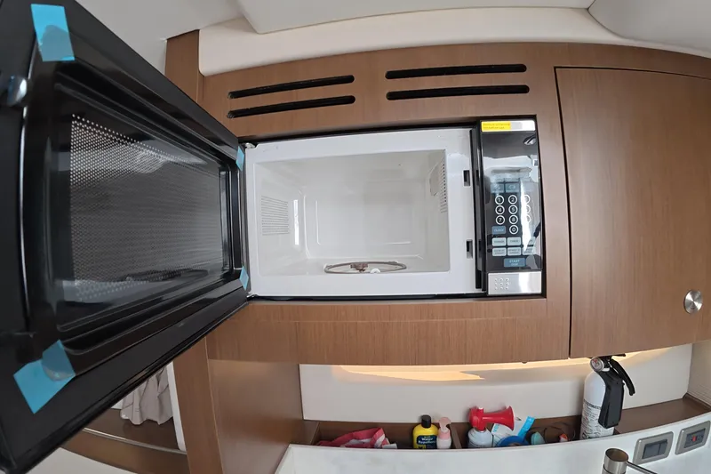 Slide: The Image of Microwave in 2021 Sea Ray Sundancer 350 Coupe yacht kitchen interior. - 23