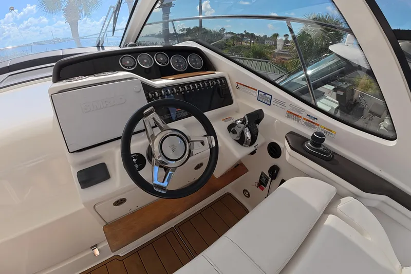 Slide: The Image of Helm of 2021 Sea Ray Sundancer 350 Coupe with modern controls and steering wheel. - 24