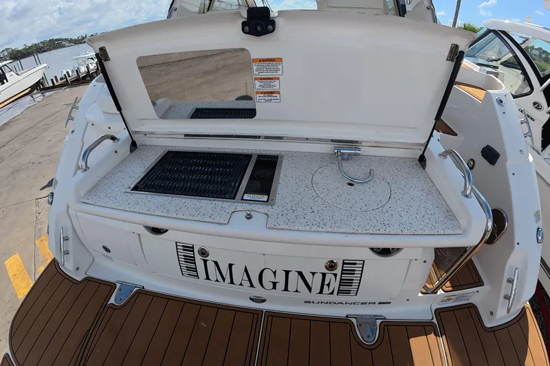 Slide: The Image of Outdoor kitchenette on 2021 Sea Ray Sundancer 350 Coupe yacht, featuring grill and sink. - 25
