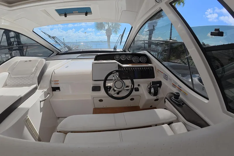 Slide: The Image of Interior cockpit of 2021 Sea Ray Sundancer 350 Coupe with steering wheel and dashboard. - 8