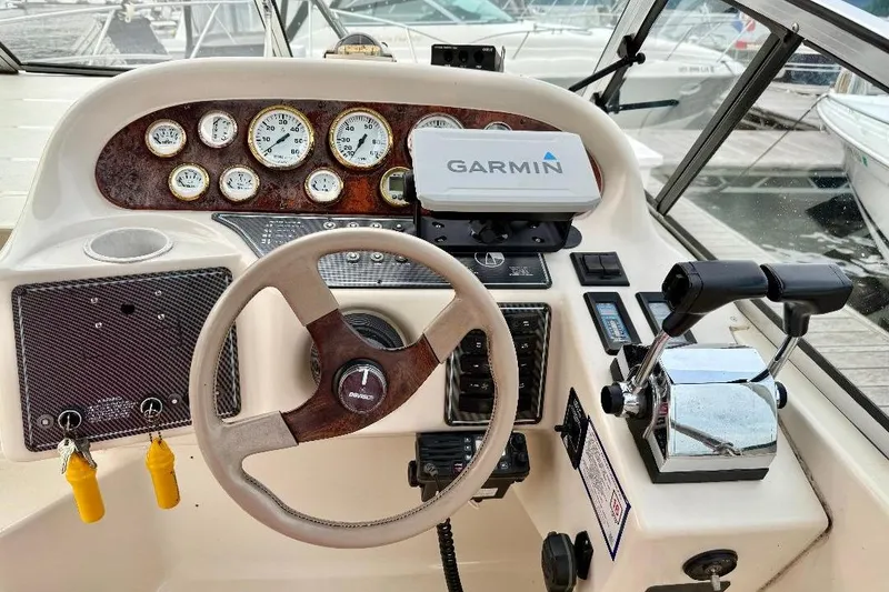Slide: The Image of 1999 Monterey 296 Cruiser helm with Garmin GPS, gauges, and controls at marina. - 2