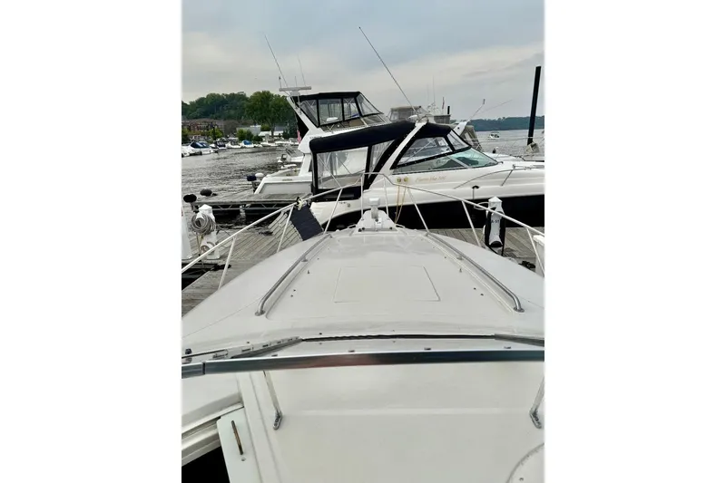 Slide: The Image of 1999 Monterey 296 Cruiser docked at marina with other boats. - 4