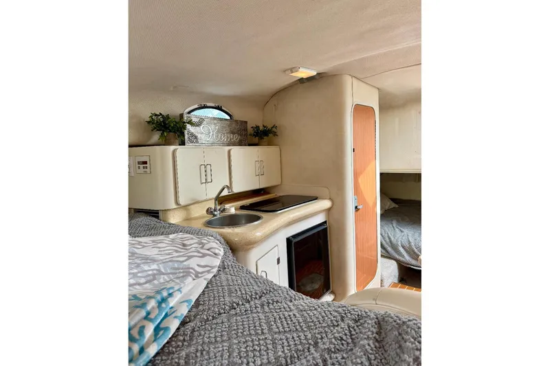 Slide: The Image of Interior of 1999 Monterey 296 Cruiser with kitchenette and cozy sleeping area. - 8