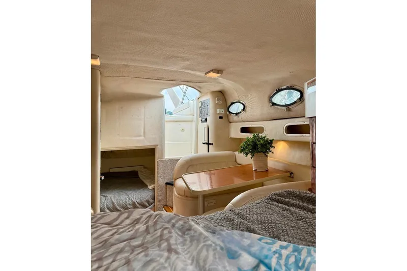 Slide: The Image of Interior of 1999 Monterey 296 Cruiser with cozy seating and porthole windows. - 9