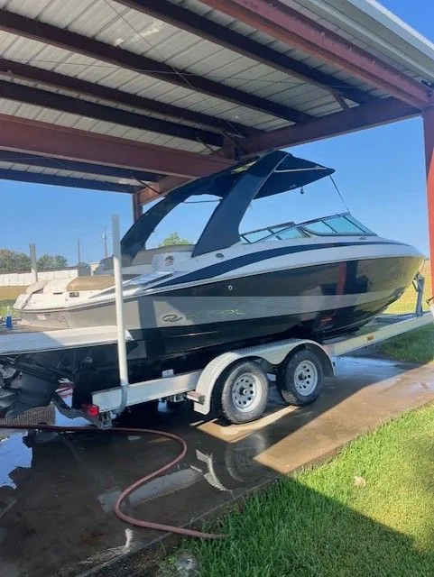 Slide: The Image of 2010 Regal 2500 boat on trailer under metal shelter. - 4