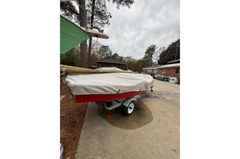 Slide: The Image of Covered 1986 One Design Point Jude 16 sailboat on trailer in driveway. - 12