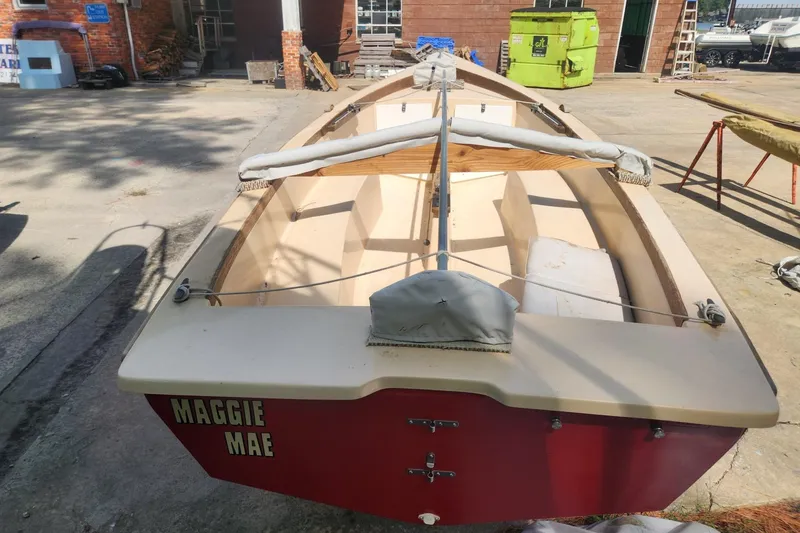 Slide: The Image of 1986 Point Jude 16 sailboat named "Maggie Mae" in a boatyard setting. - 3