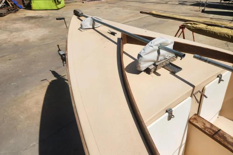 Slide: The Image of 1986 Point Jude 16 sailboat deck with rigging and fittings in a boatyard. - 6