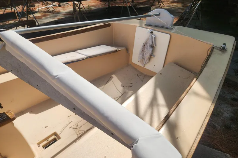 Slide: The Image of 1986 Point Jude 16 sailboat interior with seating and rigging details. - 8