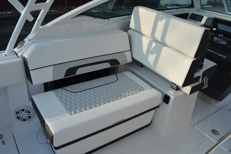 Slide: The Image of 2026 Blackfin 272 DC boat interior with white cushioned seating and modern design. - 11