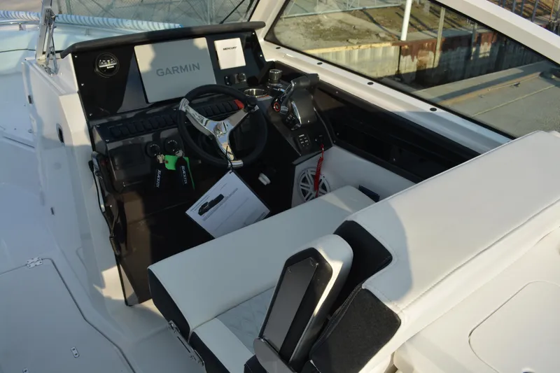 Slide: The Image of 2026 Blackfin 272 DC boat cockpit with Garmin navigation system and modern controls. - 12