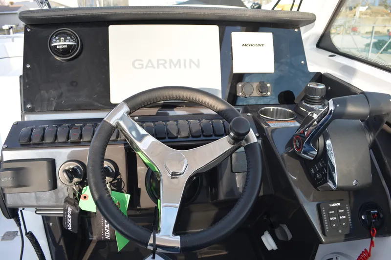 Slide: The Image of 2026 Blackfin 272 DC boat dashboard with Garmin and Mercury controls. - 13