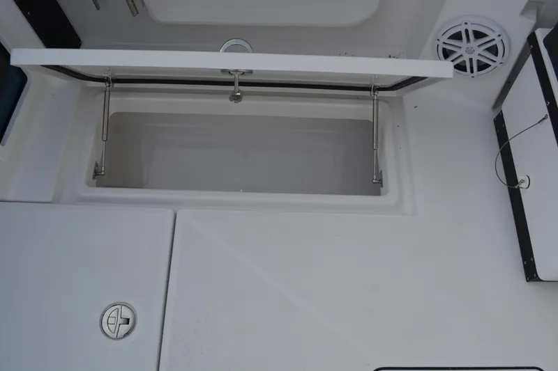 Slide: The Image of Open storage compartment on 2026 Blackfin 272 DC boat deck, featuring hydraulic hinges. - 22