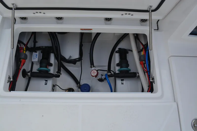 Slide: The Image of 2026 Blackfin 272 DC boat compartment with wiring and mechanical components. - 24