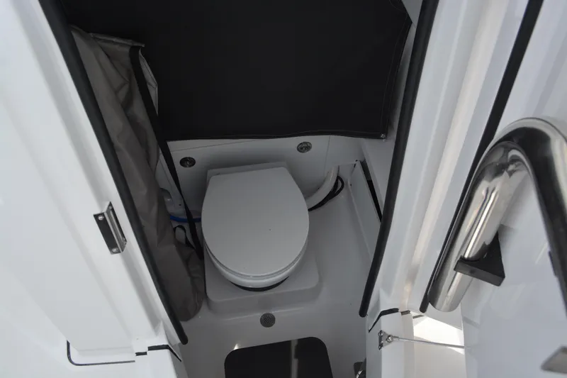 Slide: The Image of Interior view of 2026 Blackfin 252 CC boat's compact marine toilet. - 11