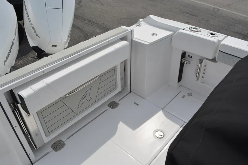 Slide: The Image of 2026 Blackfin 252 CC boat interior with Mercury engines, featuring sleek white seating and storage. - 7