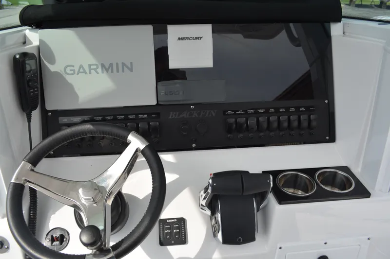 Slide: The Image of 2026 Blackfin 252 CC boat dashboard with Garmin and Mercury controls. - 9