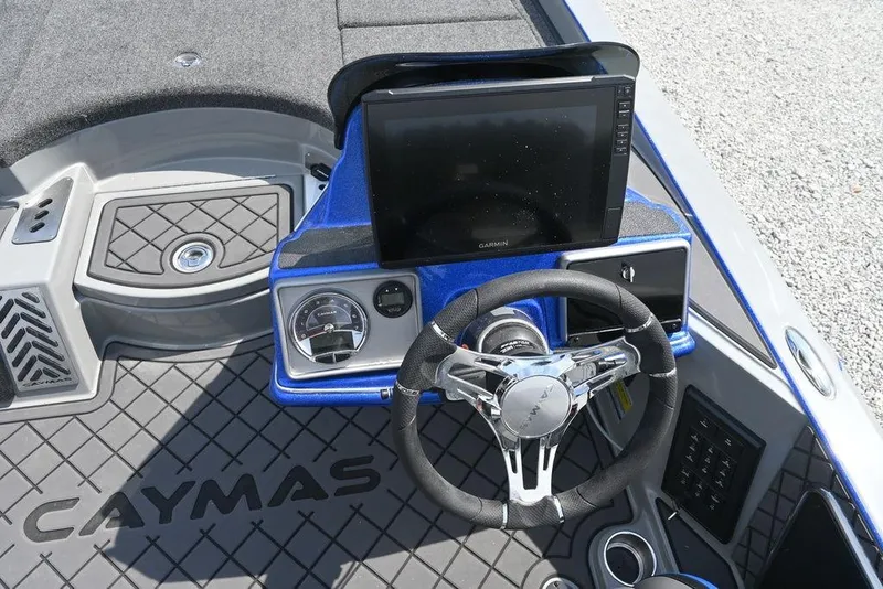 Slide: The Image of 2026 Caymas CX21 boat dashboard with Garmin display and steering wheel. - 13