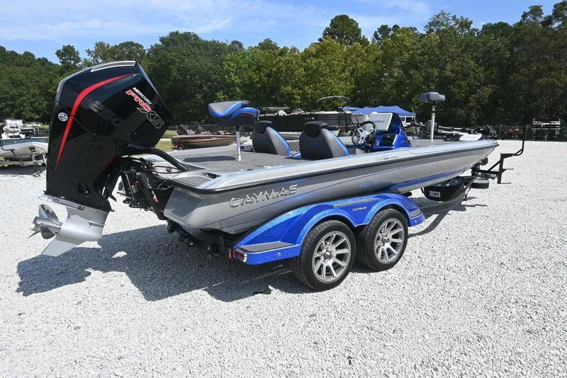 Slide: The Image of 2026 Caymas CX21 boat with powerful engine, parked on gravel, surrounded by trees. - 3