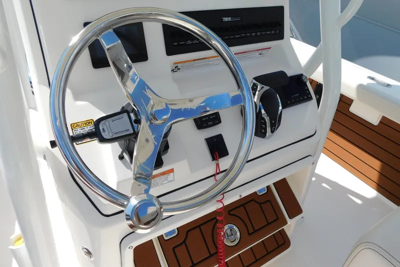 Slide: The Image of Steering console of 2026 Pathfinder 2400 TRS boat with modern controls and wood accents. - 10
