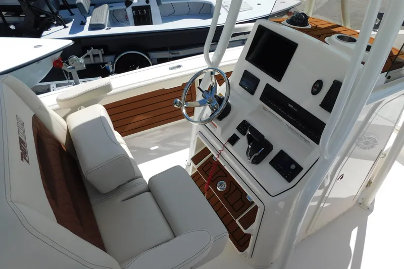 Slide: The Image of 2026 Pathfinder 2400 TRS boat console with steering wheel and navigation controls. - 11
