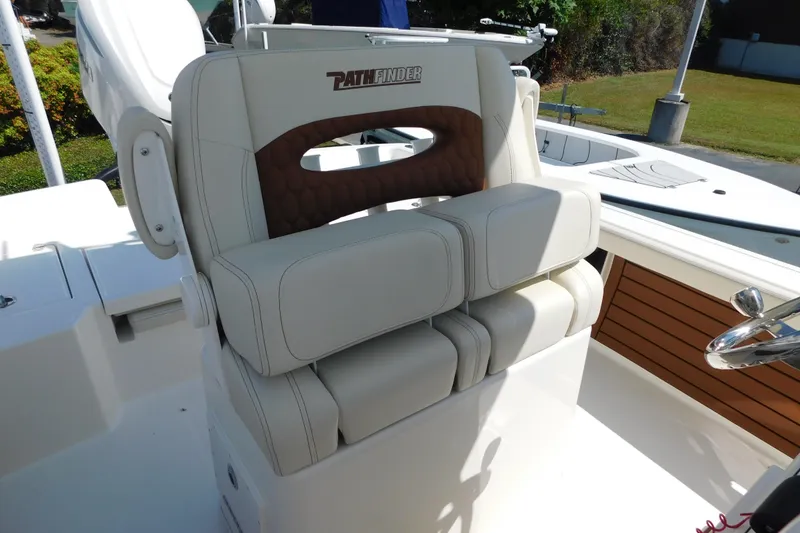 Slide: The Image of 2026 Pathfinder 2400 TRS boat seat with white and brown cushioned design. - 12