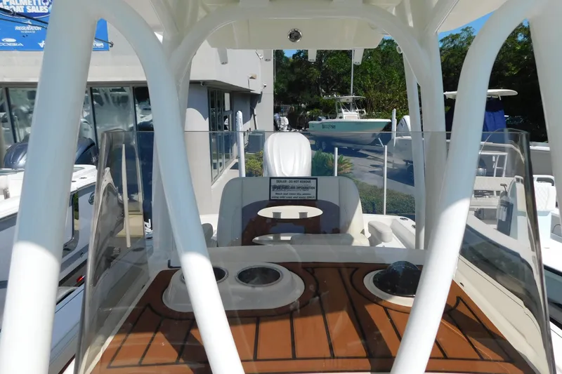 Slide: The Image of 2026 Pathfinder 2400 TRS boat interior with seating and console, displayed outdoors. - 16