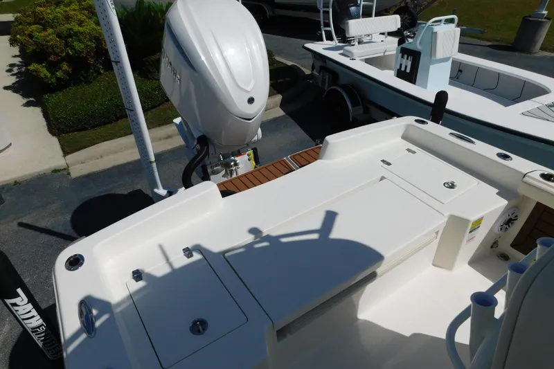 Slide: The Image of 2026 Pathfinder 2400 TRS boat with outboard motor, docked in a marina. - 17